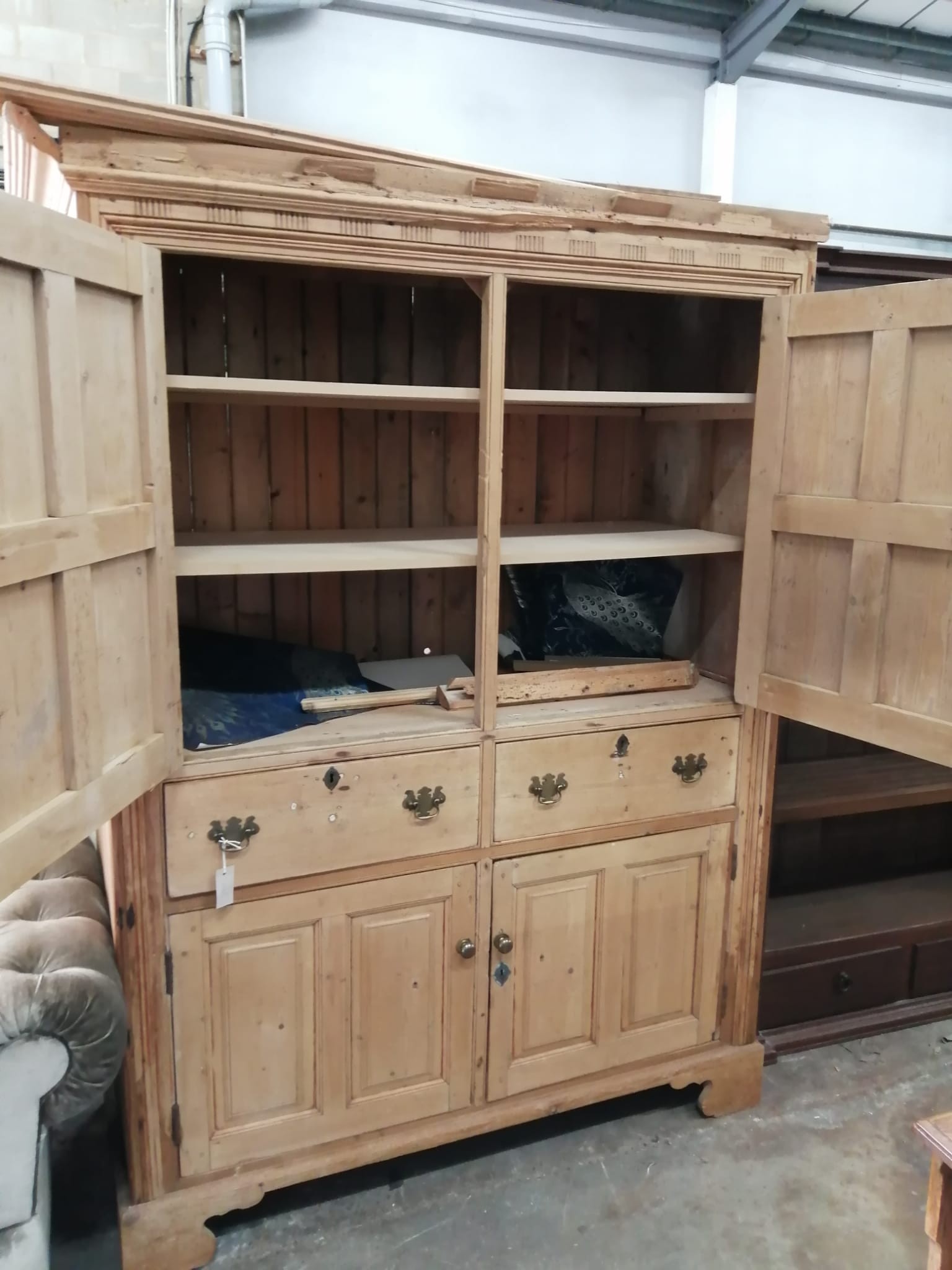 An early 19th century pine household cupboard, width 150cm, depth 65cm, height 196cm (cornice in need of repair / piece present).